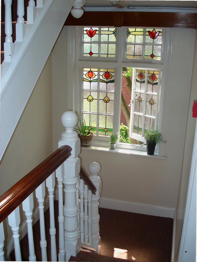 A stained-glass window on the stairwell at Open Hands Coventry